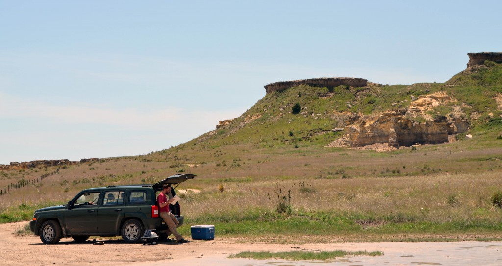 Chris Lowery writing field notes in Hays, Kansas