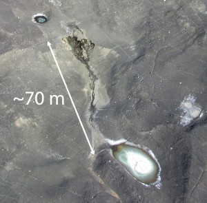 Melt out of a thermokarst gully in Garwood Valley, McMurdo Dry Valleys as seen from a helicopter. Melting ancient ice is accelerated by the presence of shallow groundwater and hypersaline ponds. (Photo courtesy Joseph Levy)