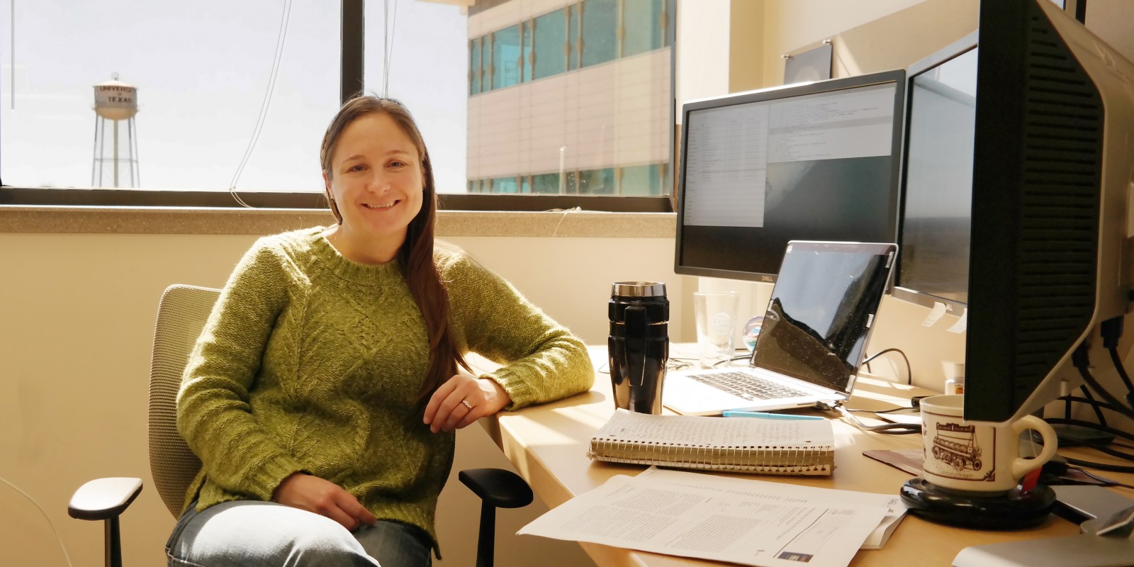 Krista Soderlund sits at her desk on the JJ Pickle Research Campus