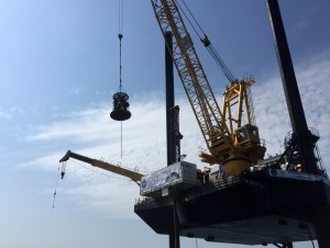 A group of scientists is transported via a lift basket from the transport vessel to the deck of the L/B Myrtle, which is approximately 10 meters above the ocean's surface. (Photo courtesy Sean P.S. Gulick)