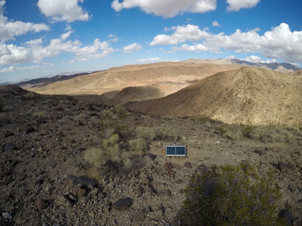 Photo of a seismic sensor in the desert.