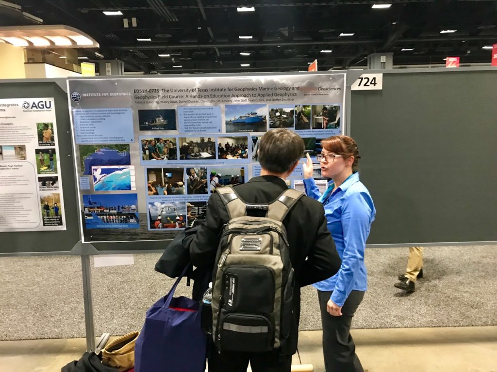 Photo of Patty at her science poster presenting to an onlooker.