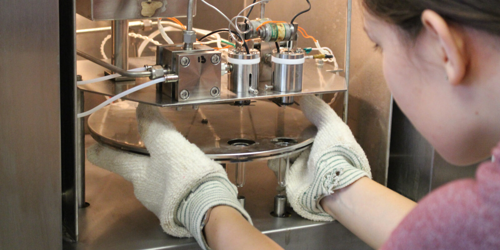 Graduate Research Assistant Allison Lawman loads coral samples into the mass spectrometer at the analytical laboratory for paleoclimate studies.