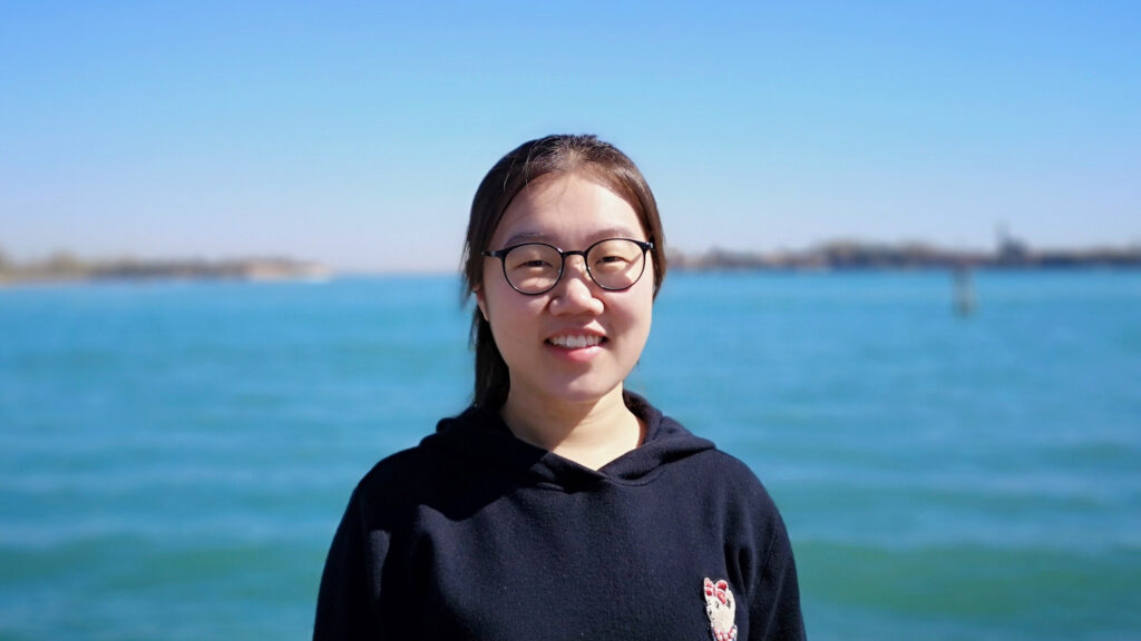 Picture of Xian in front of some water.