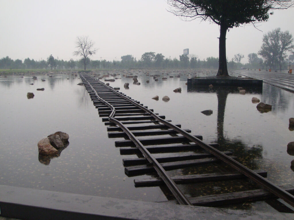 A twisted, disused railway line runs across a flooded plain at the site of China's deadliest quake in modern times.