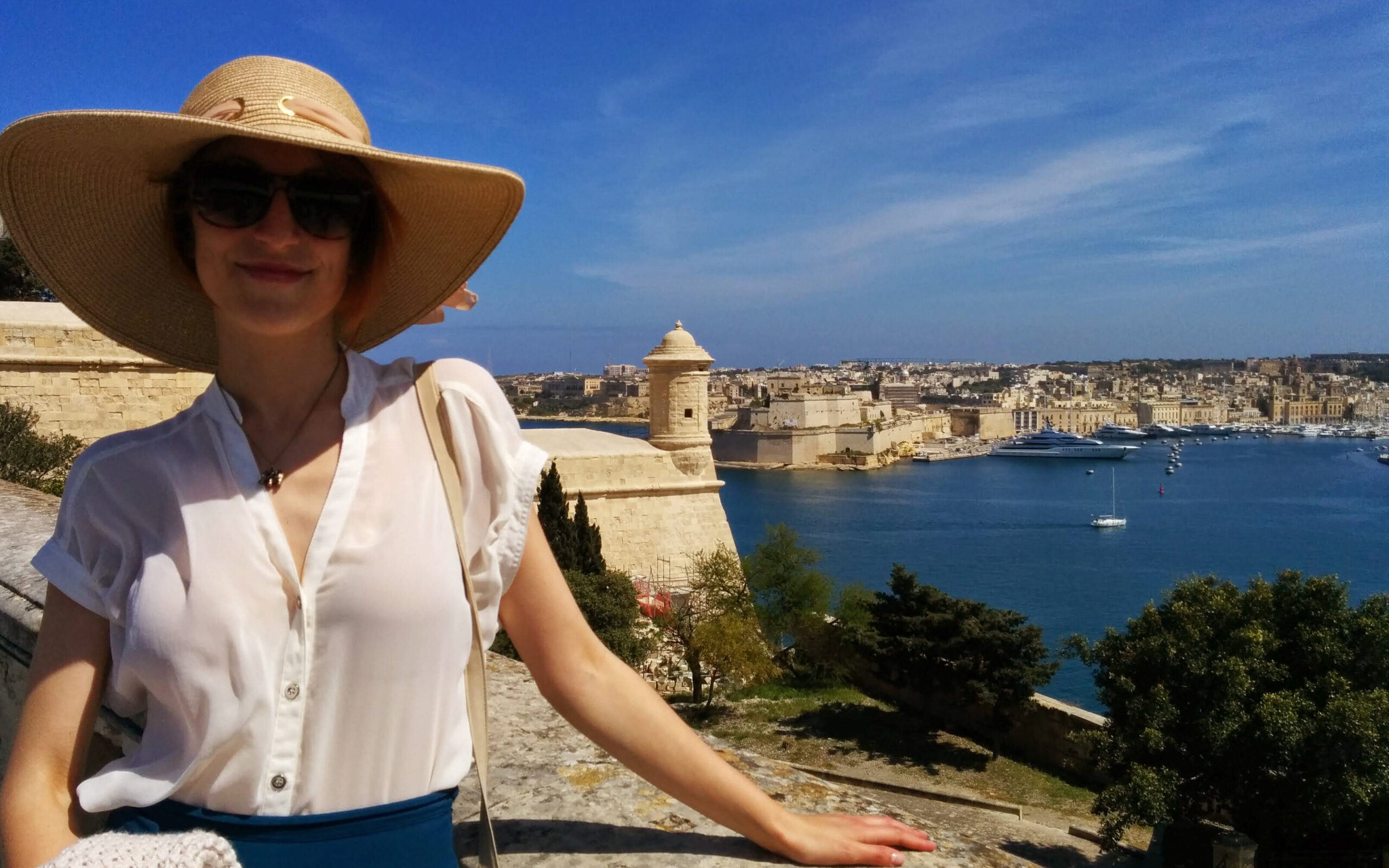 A picture of Antoniette Greta Grima with Malta's Grand Harbor behind her.