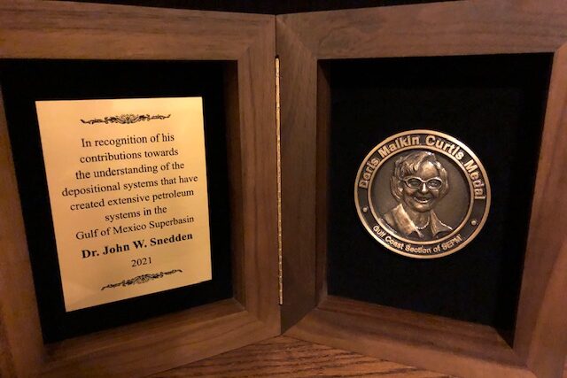 The award includes a medal depicting Doris Malkin Curtis and an engraved plaque that reads "In recognition of his contributons towards the understanding of the depositional system that have created extensive petroleum systems in the Gulf of Mexico Superbasin. Dr. John W. Sneddn. 2021"