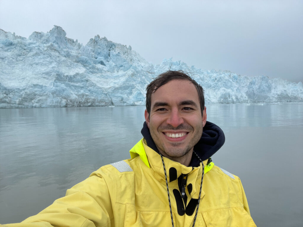 Matt Zeh taking a selfie in front of a glacier in the mist