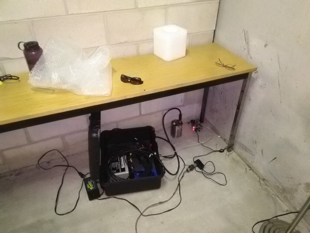 a black equipment box under a table.