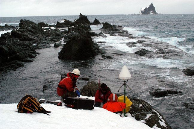 Scientists working on the icy shore