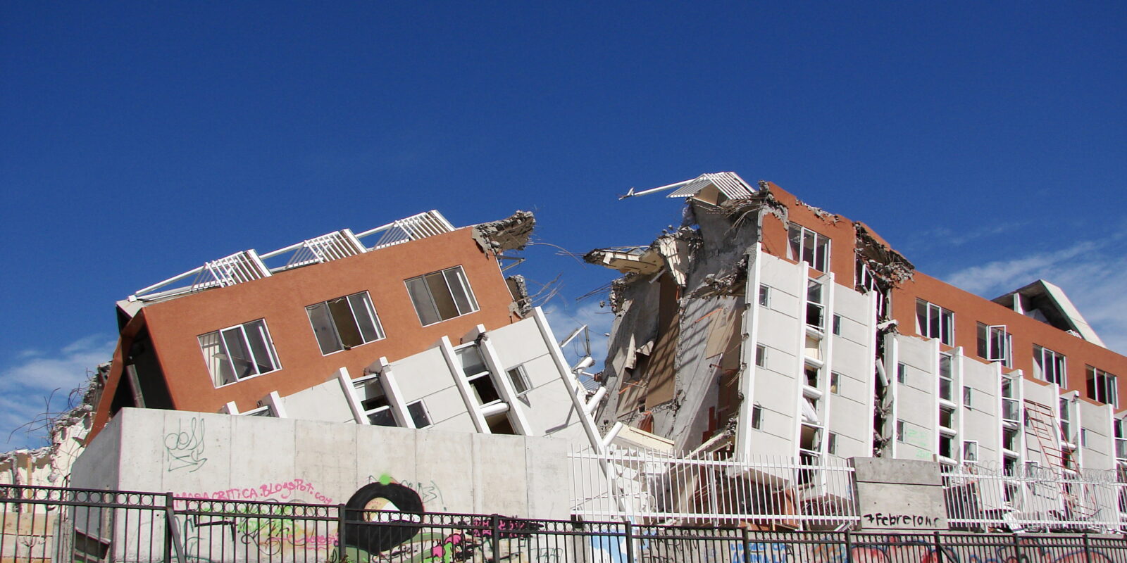 The four-storey apartment block is split in two with both sides showing major damage.