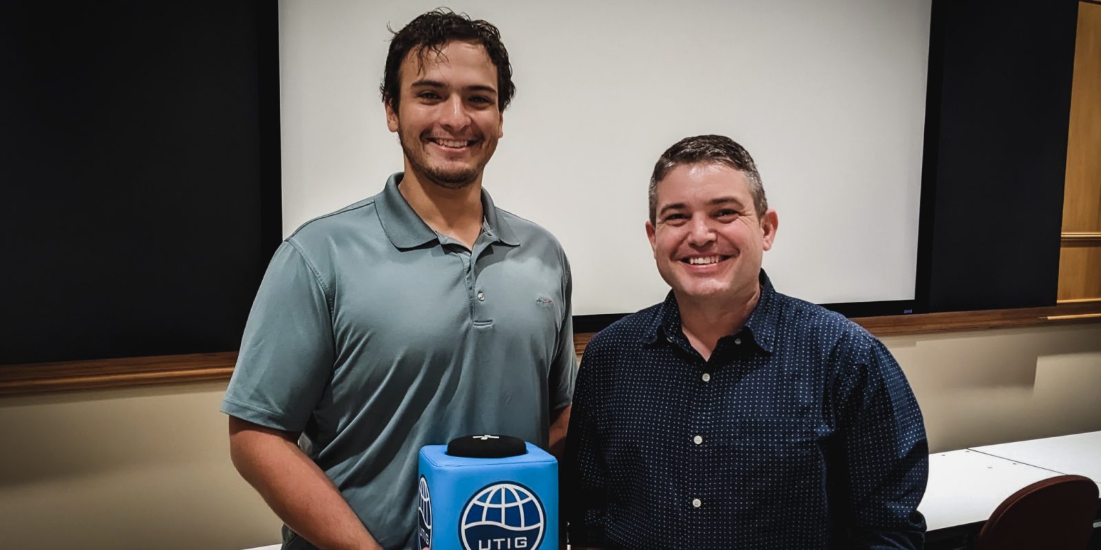 Photo of Charles holding the blue UTIG mic box with Eric.