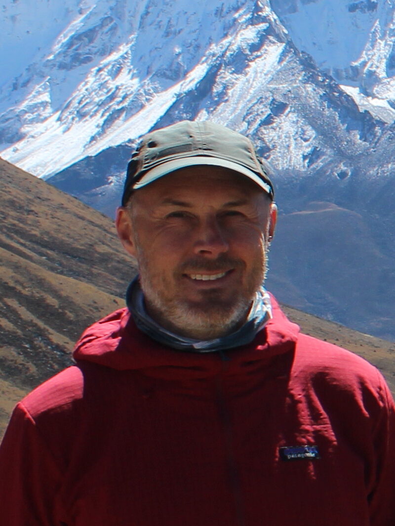 Picture of Doug Hemingway in front of snow capped mountains