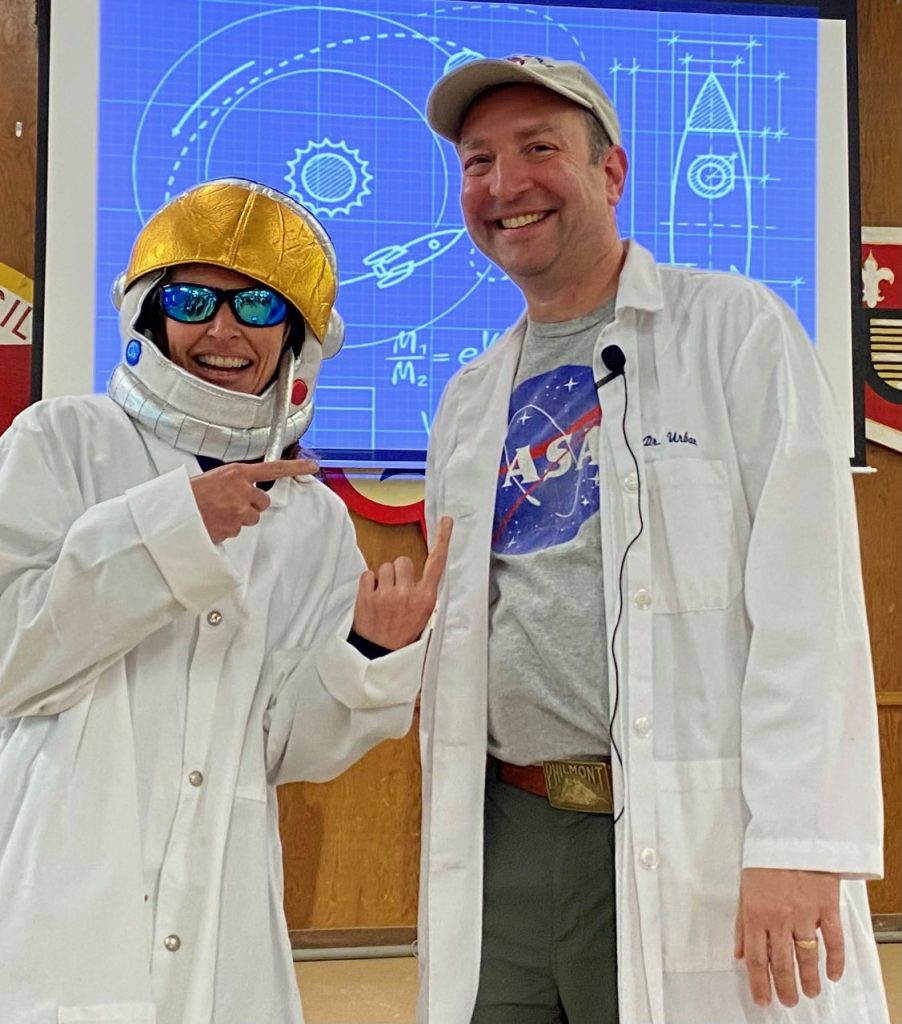 Picture of Tim wearing a Nasa t-shirt and lab coat.