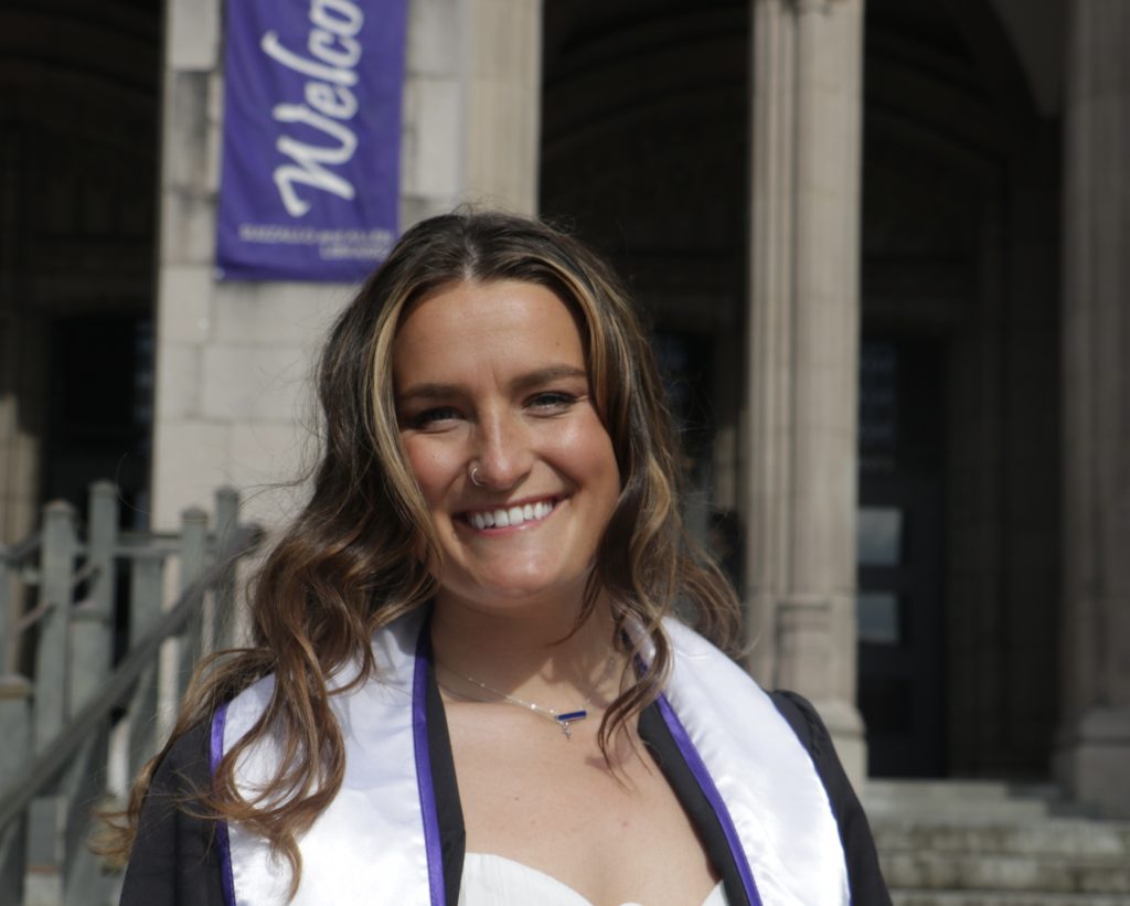 Portrait photo of Nicole wearing graduation gowns.