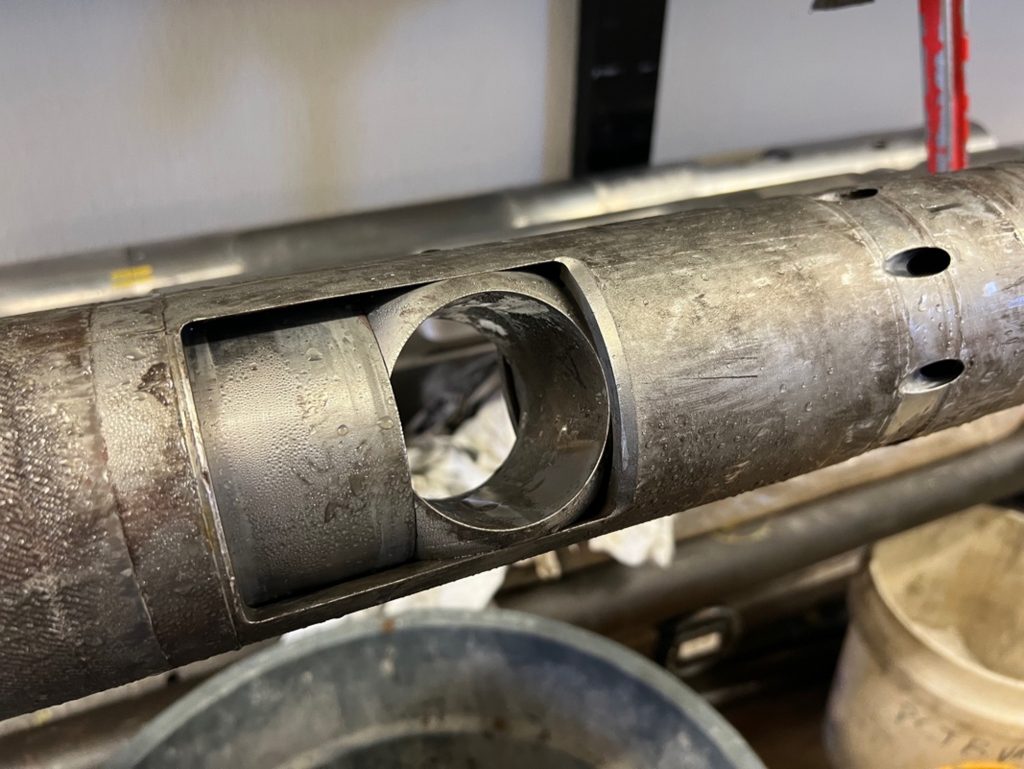 The PCTB is a tube like metal object. The ball valve in the center of the photo is hollow and has turned so that the 'closed' size is sealing what's inside. The tool looks dirty, wet and used.