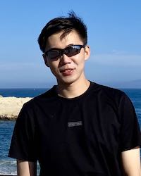 Portrait photo of Chuanming outdoors next to the sea.