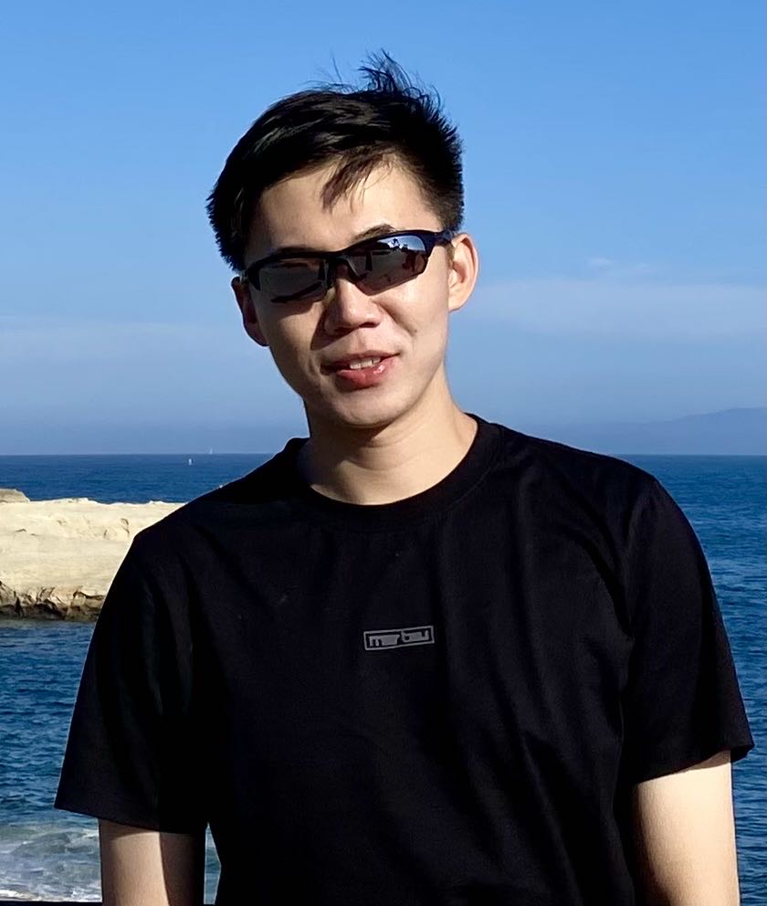 Portrait photo of Chuanming outdoors next to the sea.