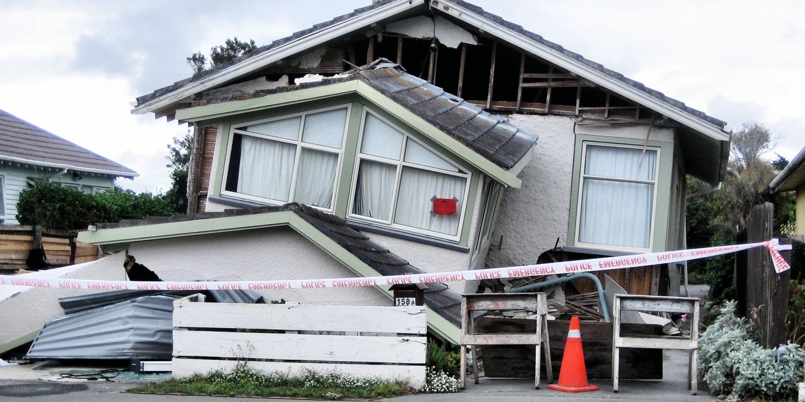 The front of the house has almost entirely collapsed. The property is sealed off with hazard tape.