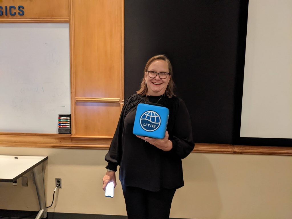 Photo of Julia Wellner holding the UTIG cube.