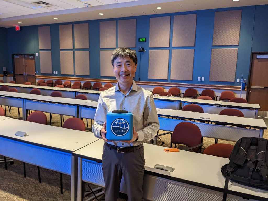 Photo of Kelin Wang holding the UTIG cube.
