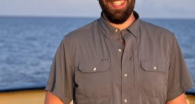 Portrait photo of Chris on the deck of a ship