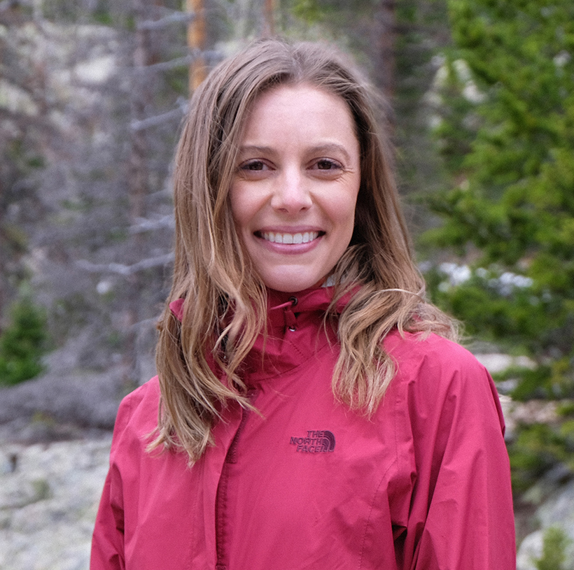 Portrait of Brandee wearing a pink rain jacket.