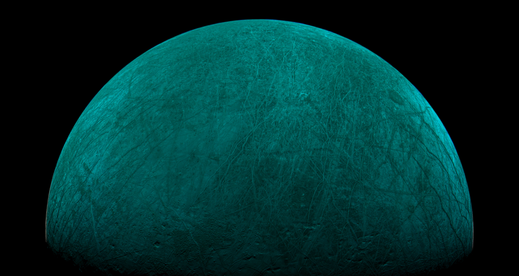 Europa from space, tinted green and partly in shadow