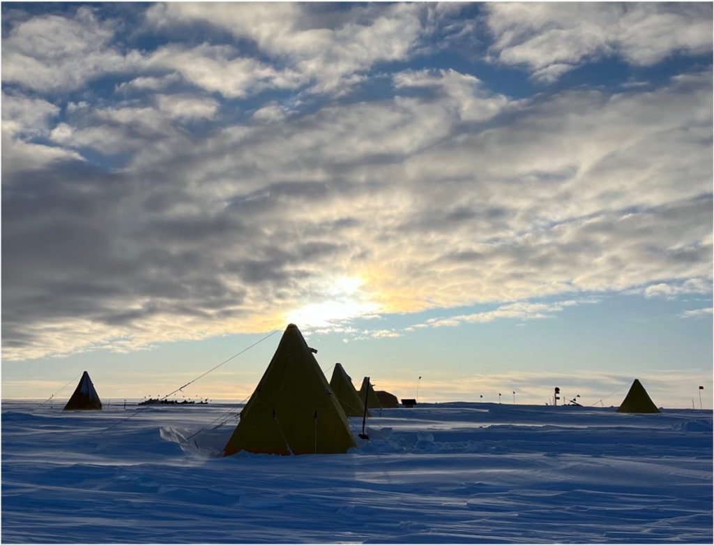 Photo of an icy landscape with tents