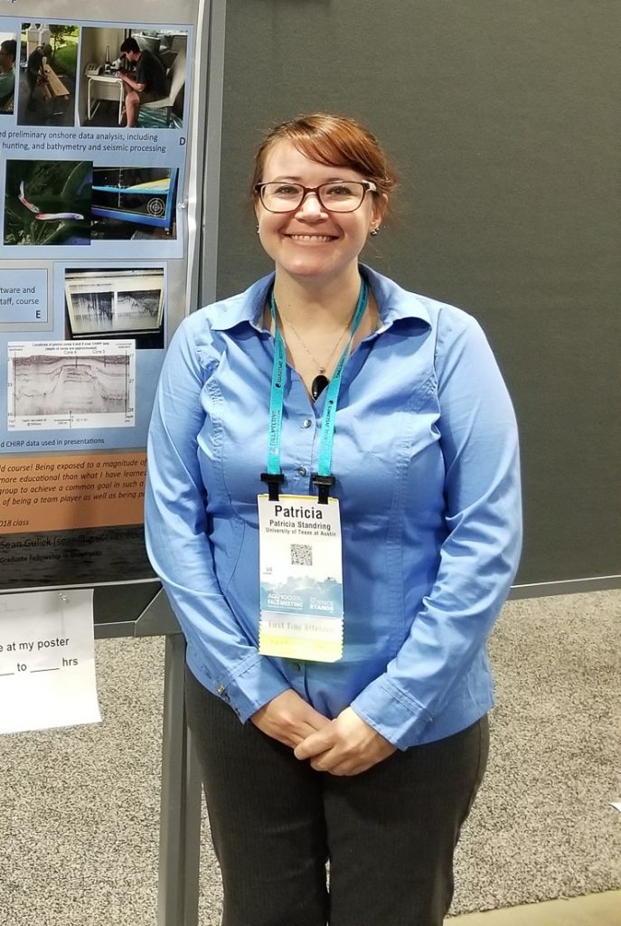 Picture of Patty standing in front of a poster stand.