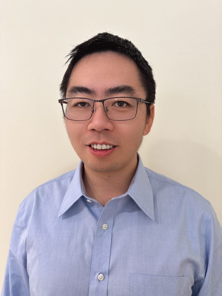 Photo portrait of Wenbo wearing a pale blue shirt.