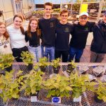 College students stand with their Plant the Moon crop experiments