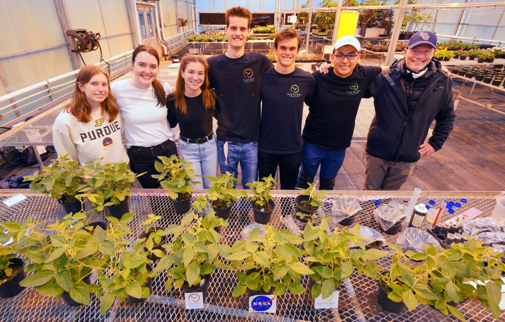 College students stand with their Plant the Moon crop experiments