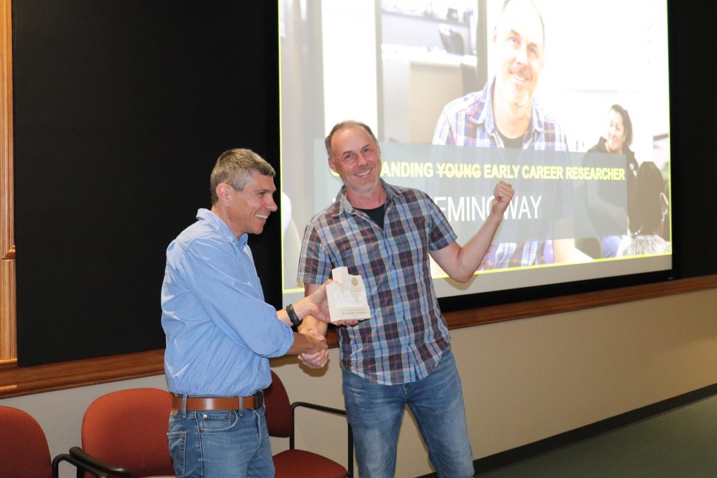 Photo of UTIG director Demian Saffer and Doug Hemingway receiving an award.
