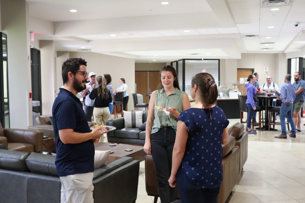 Photo of Alejandro Cardona, Perianne Johnson, and Krista Soderlund talking in the UTIG lobby.