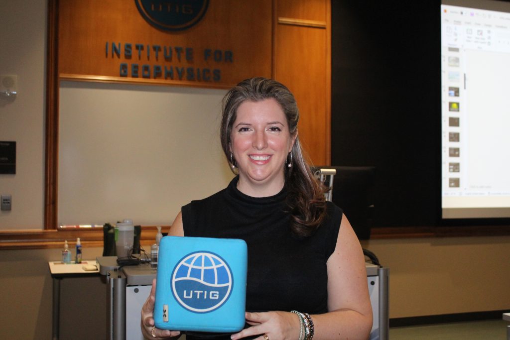 Dr. Blair Johnson poses with the UTIG cube