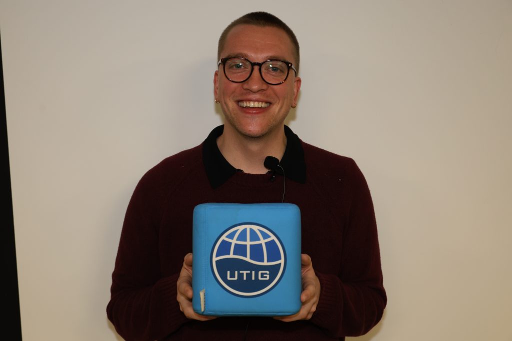 Andrew Hoffman holding the UTIG cube