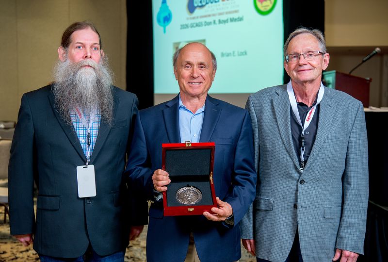 GCSSEPM President James Willis (left) and John Snedden (right) present Michael Sweet with the Doris Malkin Curtis Award at the recent GCAGS/GCSSEPM GeoGulf 2026 convention in Baton Rouge. Photo courtesy of the Gulf Coast Association of Geological Societies